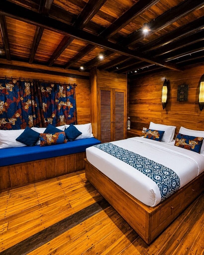 Master cabin with a double bed and a day bed under the window
