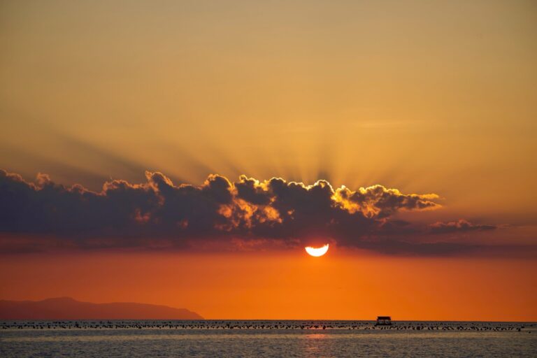 Golden sunset behind a bank of cloud over the sea in eastern Indonesia