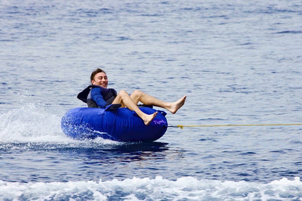 Guest being towed on an inflatable ring behind the tender