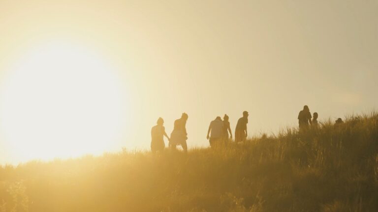 Guests hiking a Komodo hillside at golden hour