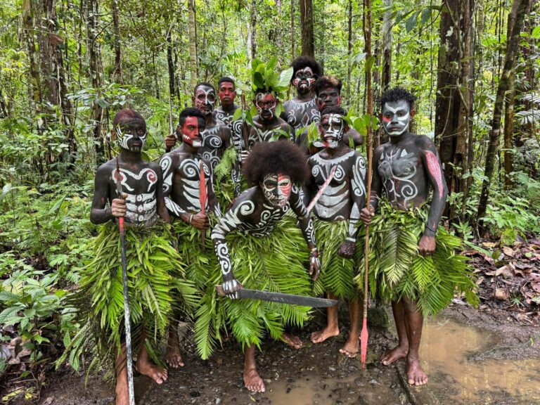 Papuan villagers in traditional body paint in the rainforest
